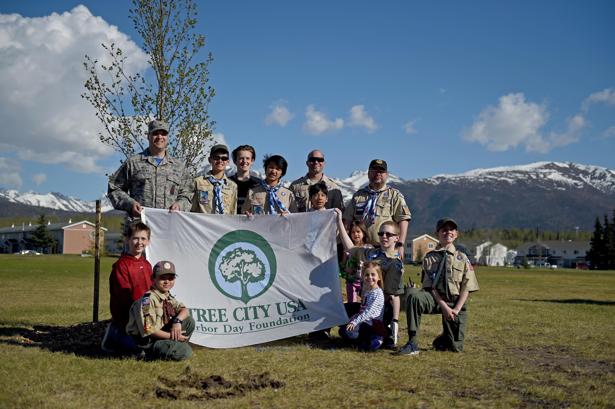 Air Force Col. Scott Matthews, 673d Civil Engineer Group commander stands with members from Joint Base Elmendorf-Richardson’s local Boy Scout Troop 190 and Cub Scout Troop 110 during an Alaska Arbor Day celebration May 12, 2017. National Arbor Day is always celebrated on the last Friday in April, however, Alaska’s Arbor Day is celebrated on the third Monday in May.