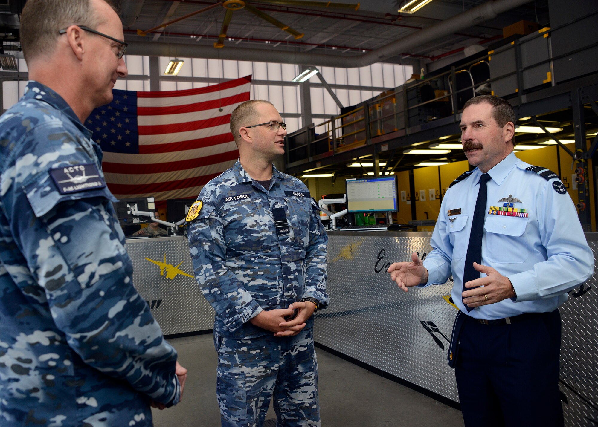 Air Marshal Gavin Davies, Royal Australian Air Force chief, speaks with Australian Airmen during his visit through the 61st Aircraft Maintenance Unit May 17, 2017, at Luke Air Force Base, Ariz. Davies was able to see the Australian maintenance in action. (U.S. Air Force photo by Senior Airman Devante Williams)