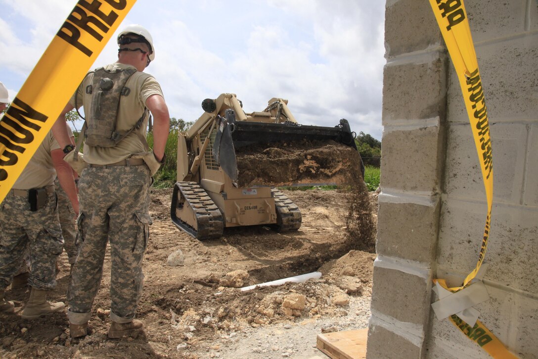 A soldier assigned to the 492nd Engineer Company based out of Mankato, Minn., covers plumbing for a septic system while building a clinic during Beyond the Horizon 2017 in Ladyville, Belize, May 11, 2017. BTH 2017 is a U.S. Southern Command-sponsored, U.S. Army South-led exercise designed to provide humanitarian and engineering services to communities in need, demonstrating U.S. support for Belize. Army photo by Spc. Kelson Brooks
