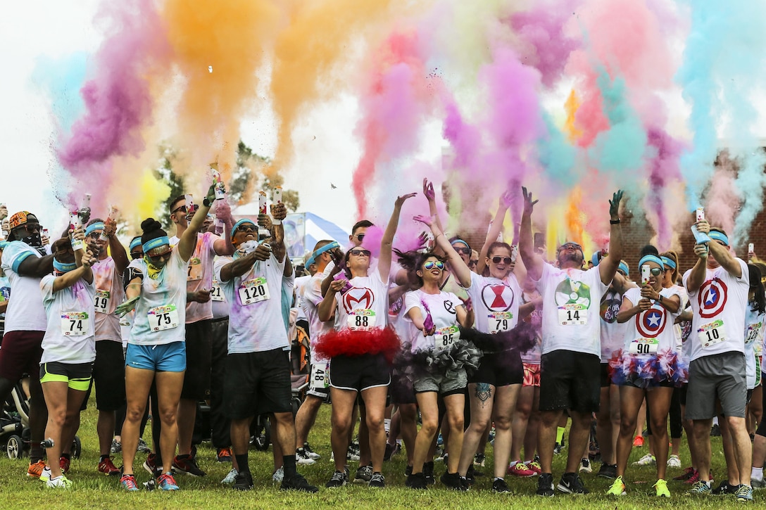 Participants in the Marine Corps Community Services Semper Fit Color Fun Run 5K shoot color cannons into the air to start the run at Marine Corps Air Station Cherry Point, N.C., May 13, 2017. More than 200 people participated in the event. Marine Corps photo by Lance Cpl. Cody Lemons