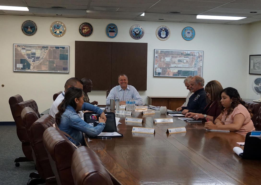 Congressman Jeff Denham is joined by the leadership of DLA Distribution San Joaquin during the command brief. Pictured around the table to his left are: his liaison, Michael Anderson Sr.; Jonathan Mathews, Installation Support site director; Damiana Maggio, AFGE 1546 president; Alexia Acosta, AFGE Local Political Coordinator; Mara Maghinay-Belasco, Installation Support organizational integrator; Fernando Lucero, AFGE 1st Vice President; and Marine Corps Col. Andre Harrell, DLA Distribution San Joaquin commander.