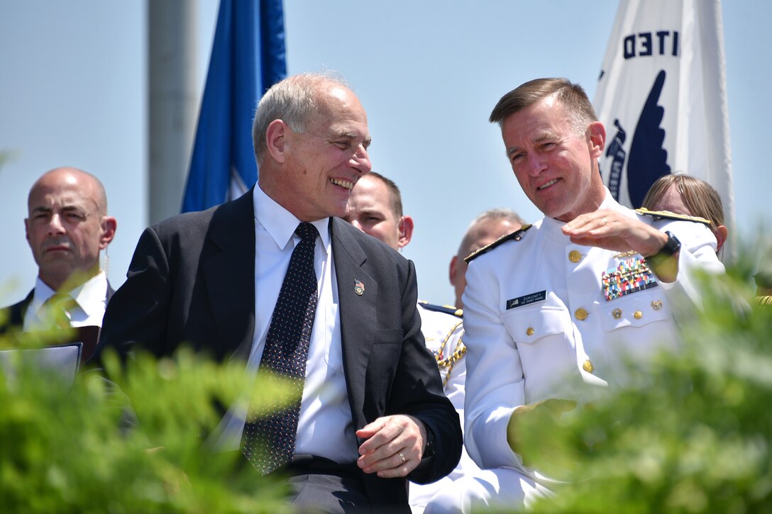 Secretary of Homeland Security John F. Kelly and Coast Guard Commandant Adm. Paul F. Zukunft share a light moment during the 136th U.S. Coast Guard Academy commencement in New London, Conn., May 17, 2017. Coast Guard photo by Petty Officer 2nd Class Patrick Kelley
