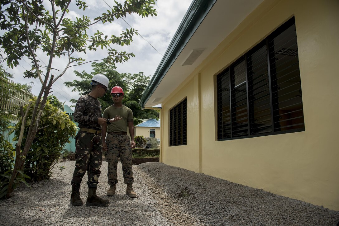 Philippine Army Capt. Armando Moncayo, Jr., left, and U.S. Marine Sgt. Lance Escobar discuss construction progress during an engineering civic assistance project in support of Balikatan 2017 in Ormoc City, Leyte, May 14, 2017. Philippine and U.S. service members worked together to build new classrooms for students at Don Carlos Elementary School. Balikatan is an annual U.S.-Philippine bilateral military exercise focused on a variety of missions, including humanitarian assistance and disaster relief, counterterrorism, and other combined military operations.