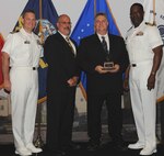 DAHLGREN, Va. (May 17, 2017) - Joseph Berenotto holds  the John Adolphus Dahlgren Award moments after receiving it from Naval Surface Warfare Center Dahlgren Division (NSWCDD) leadership at the command's annual honor awards ceremony. Berenotto was recognized for his outstanding contributions to the Submarine Launched Ballistic Missile program and NSWCDD. "Mr. Berenotto's visionary thinking and demonstrated technical leadership in employment engineering, system simulation, modeling and analysis have greatly benefited Navy strategic systems and NSWCDD's role in this program's unparalleled record of readiness and reliability," according to the citation. Standing left to right: Combat Direction Systems Activity Commanding Officer Cmdr. Andrew Hoffman; NSWCDD Technical Director John Fiore; Berenotto; and NSWCDD Commanding Officer Capt. Godfrey 'Gus' Weekes.