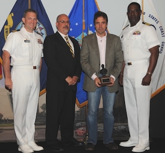 DAHLGREN, Va. (May 17, 2017) - Anthony D'Alessandro holds  the John Adolphus Dahlgren Award moments after receiving it from Naval Surface Warfare Center Dahlgren Division (NSWCDD) leadership at the command's annual honor awards ceremony. D'Alessandro was recognized for the crucial role he played in establishing NSWCDD as the undisputed leader for government designed and developed fire control systems. "Mr. D'Alessandro was a 'founding father' in the architecture and development of the MK 160 Gun Computer System and, throughout his 30 year career at Dahlgren, he has lead numerous other government fire control initiatives, most recently for the 30mm and 105mm Battle Management System gun weapon systems," according to the citation. Standing left to right: Combat Direction Systems Activity Commanding Officer Cmdr. Andrew Hoffman; NSWCDD Technical Director John Fiore; D'Alessandro; and NSWCDD Commanding Officer Capt. Godfrey 'Gus' Weekes.