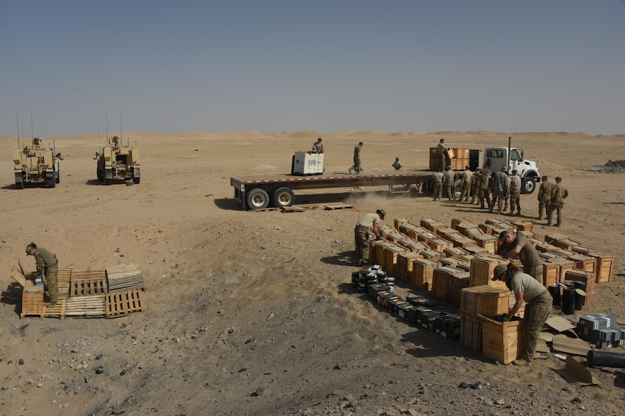 A group of explosive ordnance disposal technicians, ammunition personnel and firefighters from the 386th Air Expeditionary Wing work together to dispose of a truckload of unserviceable ordnances in a safe manner at an undisclosed location in Southwest Asia May 11, 2017. The stockpile of expired munitions consisting primarily of flares was transported to an isolated location where the unserviceable items were stacked in a man-made hole in preparation for destruction. (U.S. Air Force photo/Tech. Sgt. Jonathan Hehnly)