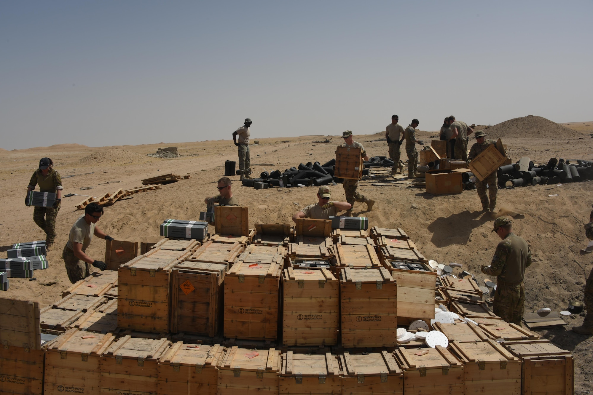 A group of Explosive Ordnance Disposal technicians, ammunition personnel and firefighters from the 386th Air Expeditionary Wing worked together to dispose of a truckload of ordnances in a safe manner at an undisclosed location in Southwest Asia, May 11, 2017. The stockpile of expired munitions consisting primarily of flares was transported to an isolated location where the unserviceable items were stacked in a man-made hole in preparation for destruction. (U.S. Air Force photo/ Tech. Sgt. Jonathan Hehnly)