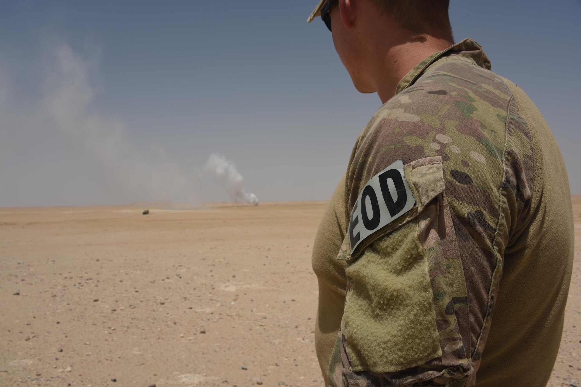 Senior Airman Merit Davey, an Explosive Ordnance Disposal journeyman with the 386th Expeditionary Civil Engineer Squadron, watches a stockpile of munitions burn from a safe distance during an ammunition disposal request burn operation at an undisclosed location in Southwest Asia, May 11, 2017. A group of EOD technicians, ammunition personnel and firefighters from the 386th Air Expeditionary Wing worked together to dispose of a truckload of expired ordnances in a safe manner at an isolated location. (U.S. Air Force photo/ Tech. Sgt. Jonathan Hehnly)
