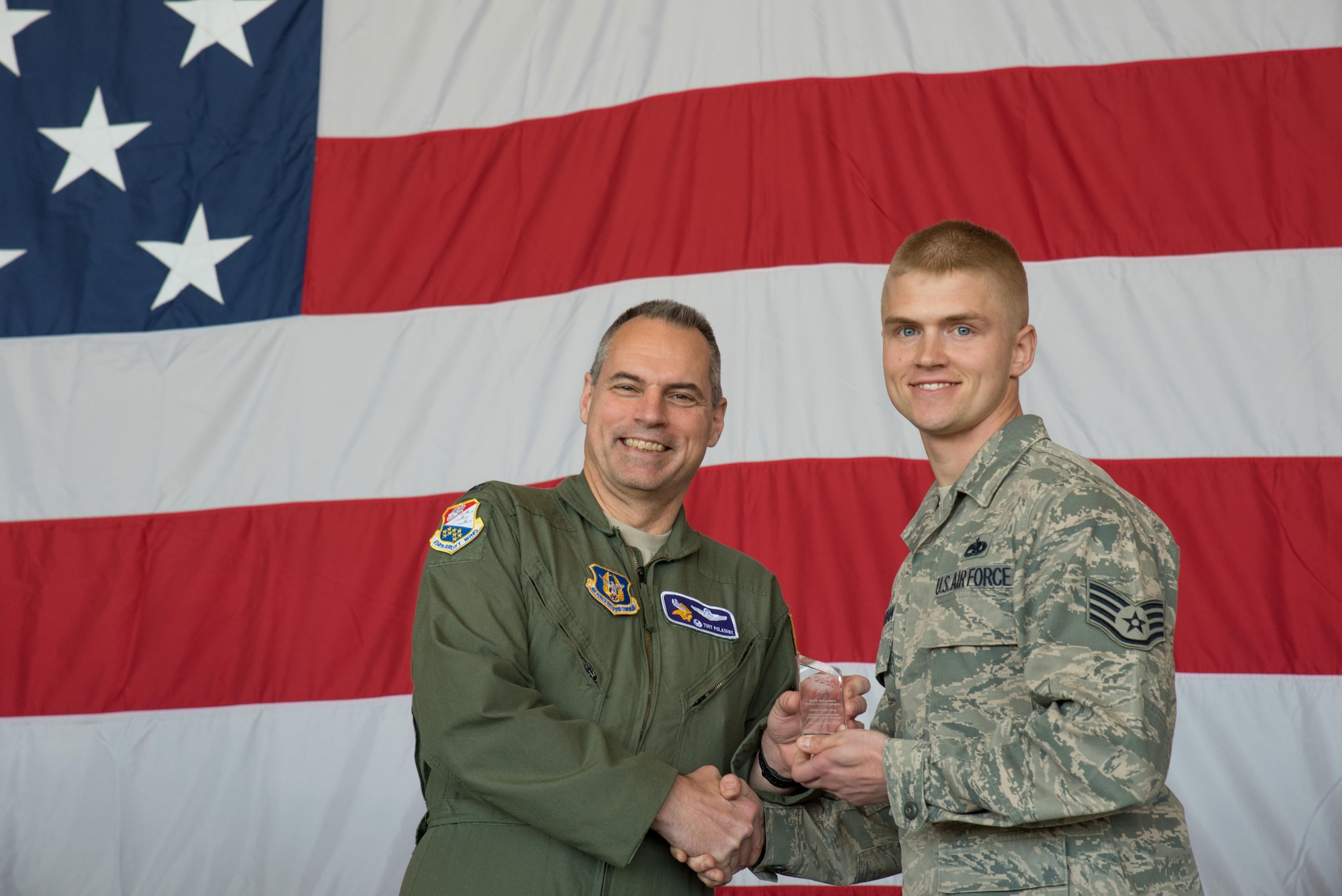 Staff Sgt. Brent Cunningham, 934th Maintenance Squadron (right) receives the Noncommissioned Officer of the Quarter award from Col. Tony Polashek, 934th Airlift Wing commander, at the Wing Commander's Call May 6. (Air Force Photo/Master Sgt. Eric Amidon)