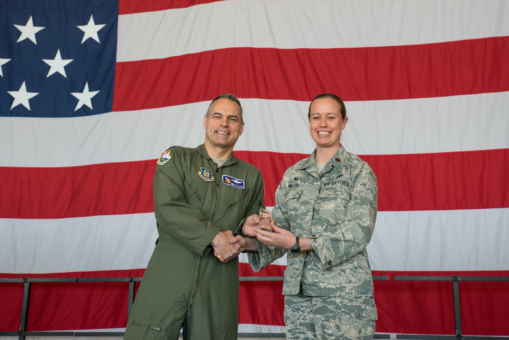 Maj. Grace Miller, 934th Aircraft Maintenance Squadron (right) receives the Company Grade Officer of the Year award from Col. Tony Polashek, 934th Airlift Wing commander, at the Wing Commander's Call May 6. (Air Force Photo/Master Sgt. Eric Amidon)