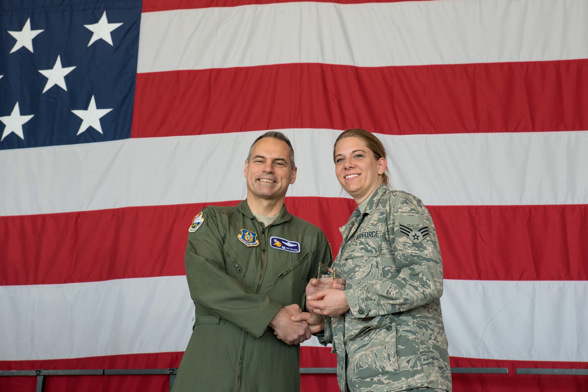 Senior Airman Hannah Keaton, 934th Operations Support Squadron, (right) receives the Airman of the Year Award from Col. Tony Polashek, 934th Airlift Wing commander, at the Wing Commander's Call May 6. (Air Force Photo/Master Sgt. Eric Amidon)