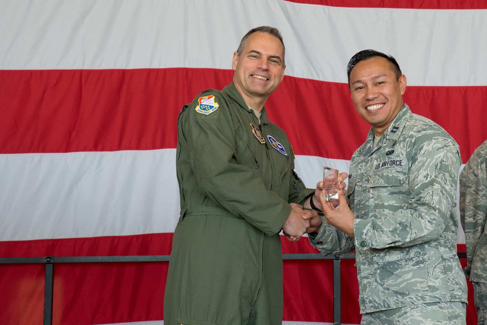 Capt. Francisco Vidal, 934th Aeromedical Evacuation Squadron, (right) receives the Company Grade Officer of the Quarter award from Col. Tony Polashek, 934th Airlift Wing commander, at the Wing Commander's Call May 6. (Air Force Photo/Master Sgt. Eric Amidon)