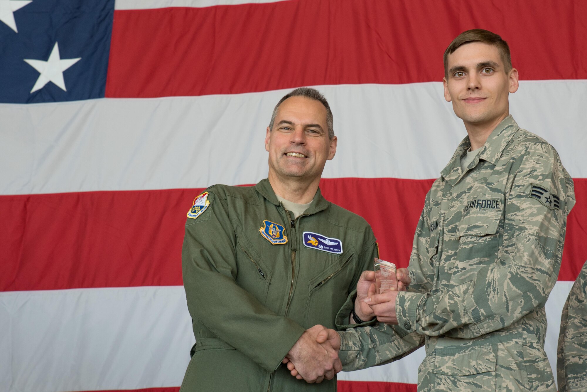Senior Airman Alex Schaak, 934th Maintenance Squadron (right) receives the Airman of the Quarter award from Col. Tony Polashek, 934th Airlift Wing commander, at the Wing Commander's Call May 6. (Air Force Photo/Master Sgt. Eric Amidon)