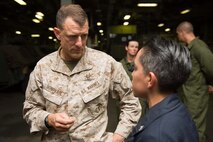 U.S. 5TH FLEET AREA OF OPERATIONS (May 14, 2017) Brig. Gen. Francis Donovan speaks with Boatswain's Mate 3rd Class Jessica Gamez in the well deck of the amphibious assault ship USS Bataan (LHD 5) as part of a ship tour during exercise Eager Lion 2017. Eager Lion is an annual U.S. Central Command exercise in Jordan designed to strengthen military-to-military relationships between the U.S., Jordan and other international partners. This year's iteration is comprised of about 7,200 military personnel from more than 20 nations that will respond to scenarios involving border security, command and control, cyber defense and battlespace management. The ship and its ready group are deployed in the U.S. 5th Fleet area of operations in support of maritime security operations designed to reassure allies and partners, and preserve the freedom of navigation and the free flow of commerce in the region.
