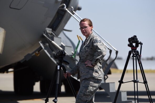 Staff Sgt. Jessica Keys, 367th Training Support Squadron, configures her camera equipment to capture video of a C-17 Globemaster at Travis Air Force Base, California, for a Foreign Object Damage and Dropped Object Prevention Program (FOD/DOPP) training video. (U.S. Air Force/Tech. Sgt. Rudy Gonzales)