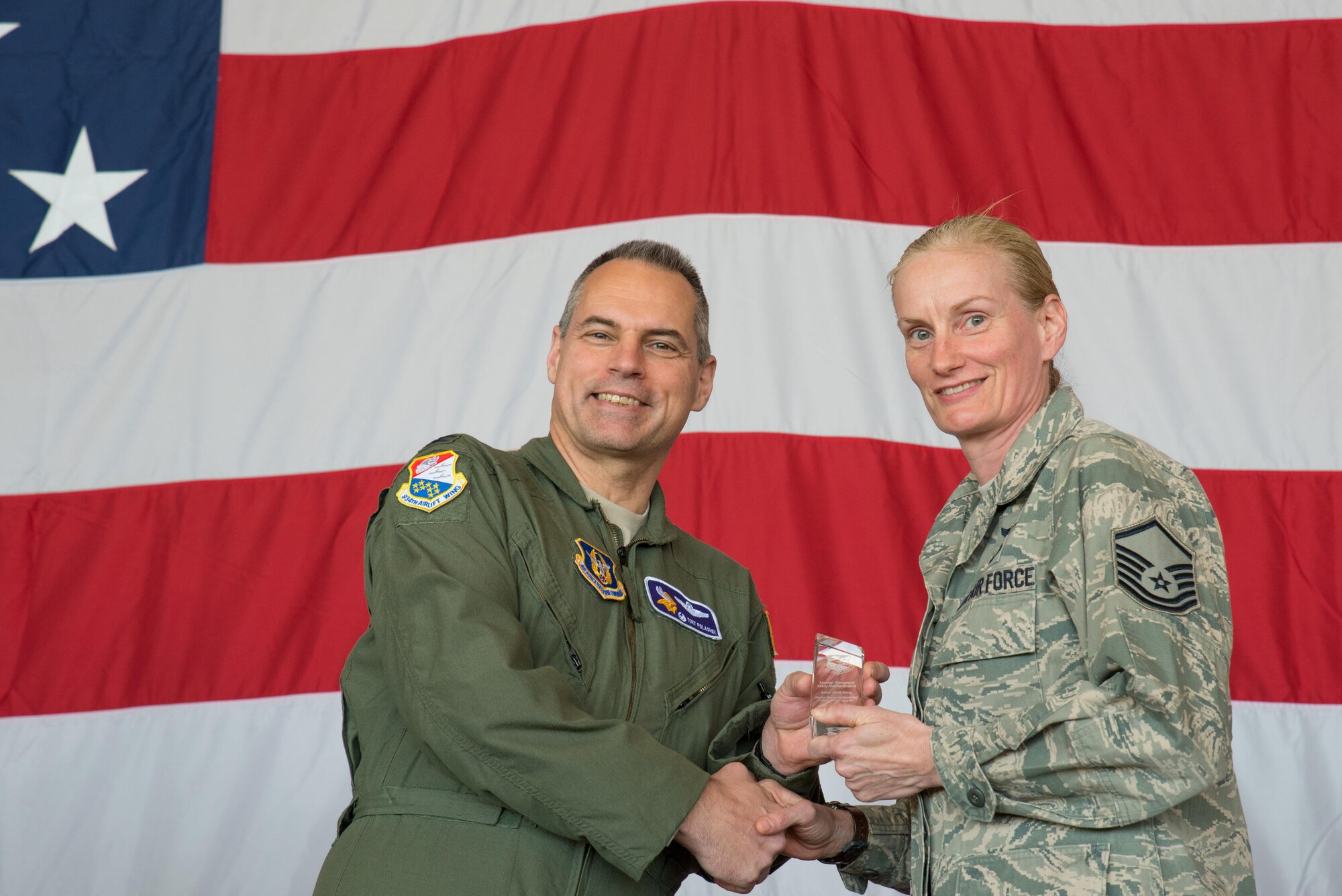 Master Sgt. Mary Wetterstrand, 934th Aeromedical Evacuation Squadron (right) receives the Senior Noncommissioned Officer of the Quarter award from Col. Tony Polashek, 934th Airlift Wing commander, at the Wing Commander's Call May 6. (Air Force Photo/Master Sgt. Eric Amidon)