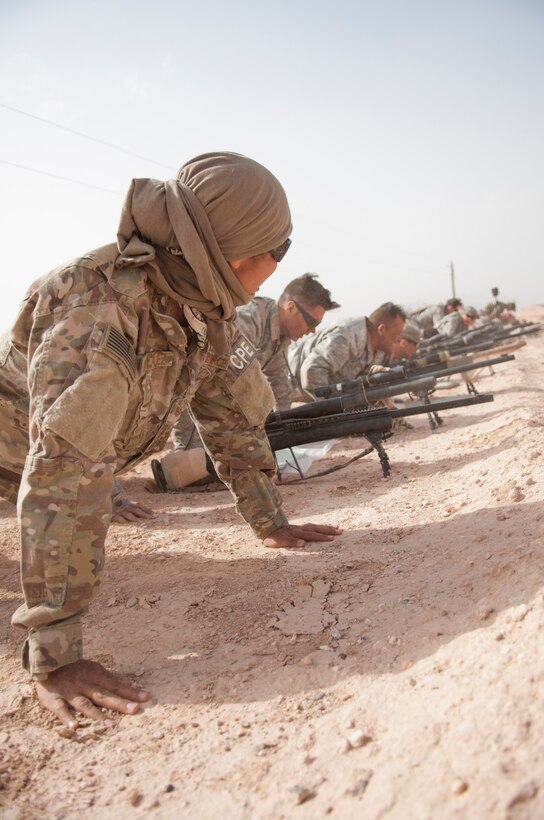 Tech. Sgt. Elizabeth Gonzalez, assigned to the 203rd Security Forces Squadron, Texas Air National Guard, motivates a group of Close Precision Engagement Course trainees during physical training before they take part in a range estimation qualification test at the Dona Ana Range Complex April 25, 2017.  Gonzalez is the non-commissioned officer in charge and teaches advanced precision marksmanship and military scouting skills to Air Force security forces members at the Desert Defender Ground Readiness Combat Training Center in Fort Bliss, Texas. (Air National Gaurd Photo by Staff Sgt. Agustin G. Salazar)
