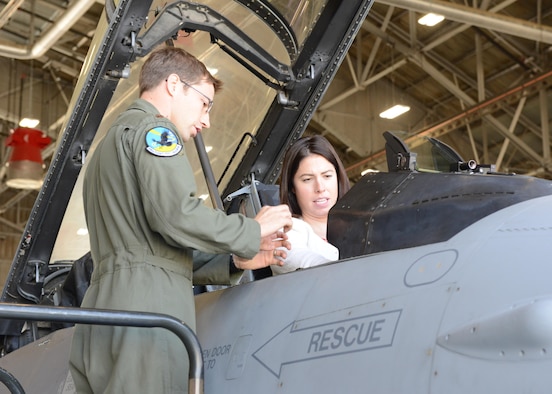 Maj. Philip Jackson, 416th Flight Test Squadron, explains the inner workings of an F-16 Fighting Falcon cockpit to congressional staffer Megan Zavertnik May 10. Zavertnik works for U.S. Congressman Steve Knight, who represents California’s 25th Congressional District. Also visiting were staff members from Congressman Kevin McCarthy’s office, Tiffanii Woolfolk and Braden Murphy. (U.S. Air Force photo by Kenji Thuloweit)