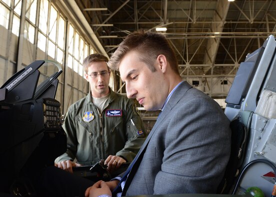 Braden Murphy, a congressional staff member from U.S. Congressman Kevin McCarthy’s office, sits in the cockpit of an F-16 Fighting Falcon as Maj. Philip Jackson, 416th Flight Test Squadron, explained some of the control features. Murphy was one of three congressional staffers who visited Edwards May 10. (U.S. Air Force photo by Kenji Thuloweit)