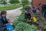 Installation Support site director Dan Bell (left) and environmental specialist Nicole Goicochea (center) supervise the Pre-K students as they plant their summer learning garden with vegetables, herbs and flowers.
