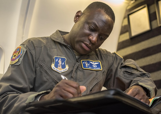 Tech. Sgt. Anthony Montgomery, 201st Airlift Squadron flight attendant, takes pre-flight notes before a Mission Readiness Airlift at Joint Base Andrews, Md., March 31, 2017. The 201st AS supports a flying schedule consisting of approximately five large trips a month that range from five to 12 days and go almost anywhere around the world. (U.S. Air Force photo by Senior Airman Jordyn Fetter)