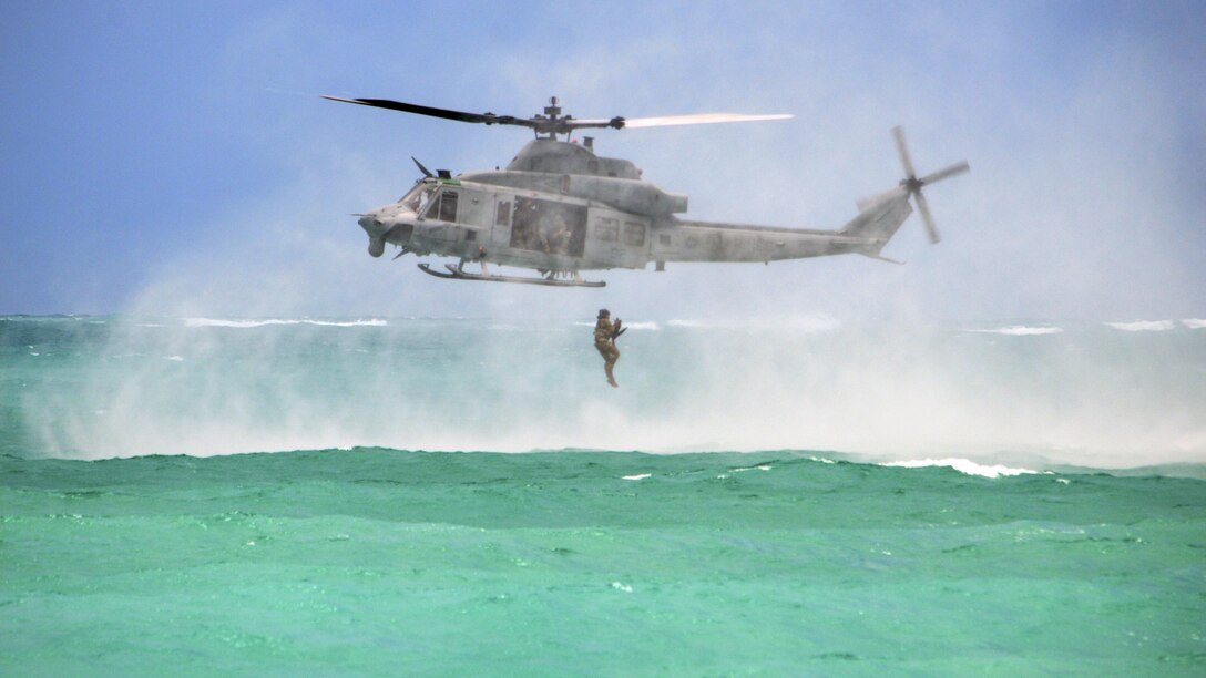A soldier jumps from a Marine Corps UH-1Y Huey helicopter into the Pacific Ocean near Marine Corps Training Area Bellows, Hawaii, May 16, 2017, during helocast insertion training. The soldier is assigned to 25th Infantry Division’s 3rd Squadron, 4th Cavalry Regiment, 3rd Brigade Combat Team. Army photo by Staff Sgt. Armando R. Limon
