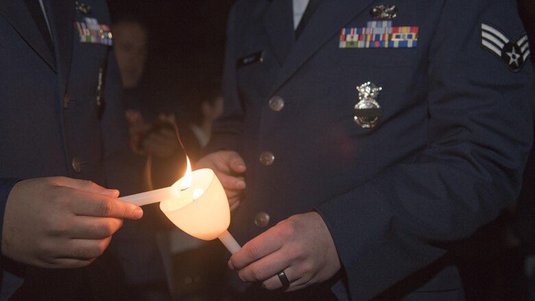 11th Security Forces Group members light candles during the 29th Annual Candlelight Vigil in Washington, D.C., May 13, 2017. This was one of the National Police Week events held to bring together law enforcement from around the world and honor past and present police officers and security forces members. (U.S. Air Force photo by Airman 1st Class Valentina Lopez)