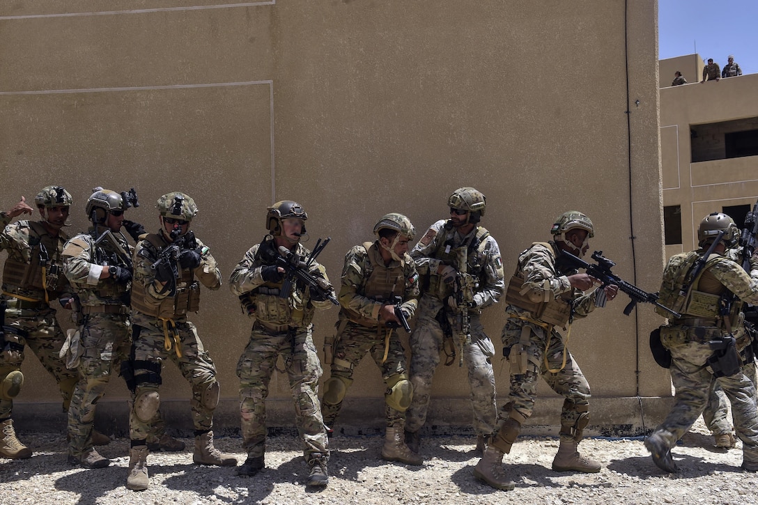 Air Force special tactics airmen, Italian special operations forces and members of the Jordanian Armed Forces Special Task Force conduct a simulated assault on a compound during exercise Eager Lion 17 at King Abdullah II Special Operations Training Center in Amman, Jordan, May 11, 2017. Air Force photo by Senior Airman Ryan Conroy