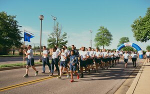 Airmen with the 11th Mission Support Group run in formation during the Wingman/Shipmate Day 5K at Joint Base Andrews, Md., May 16, 2017. Wingman/Shipmate Day is a day for Airmen and Sailors to strengthen bonds and build new ones. (U.S. Air Force photo by Senior Airman Delano Scott)