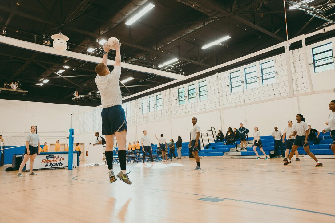 Airmen compete in a volleyball game during Wingman/Shipmate Day at Joint Base Andrews, Md., May 16, 2017. Wingman/Shipmate Day is a day for Airmen and Sailors to strengthen bonds and build new ones. (U.S. Air Force photo by Senior Airman Delano Scott)