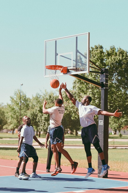 Airmen go up for a rebound during a basketball game as part of Wingman/Shipmate Day at Joint Base Andrews, Md., May 16, 2017. Wingman/Shipmate Day supports comradery and fosters better relationships between JBA members through sports and other activities. (U.S. Air Force photo by Senior Airman Delano Scott)