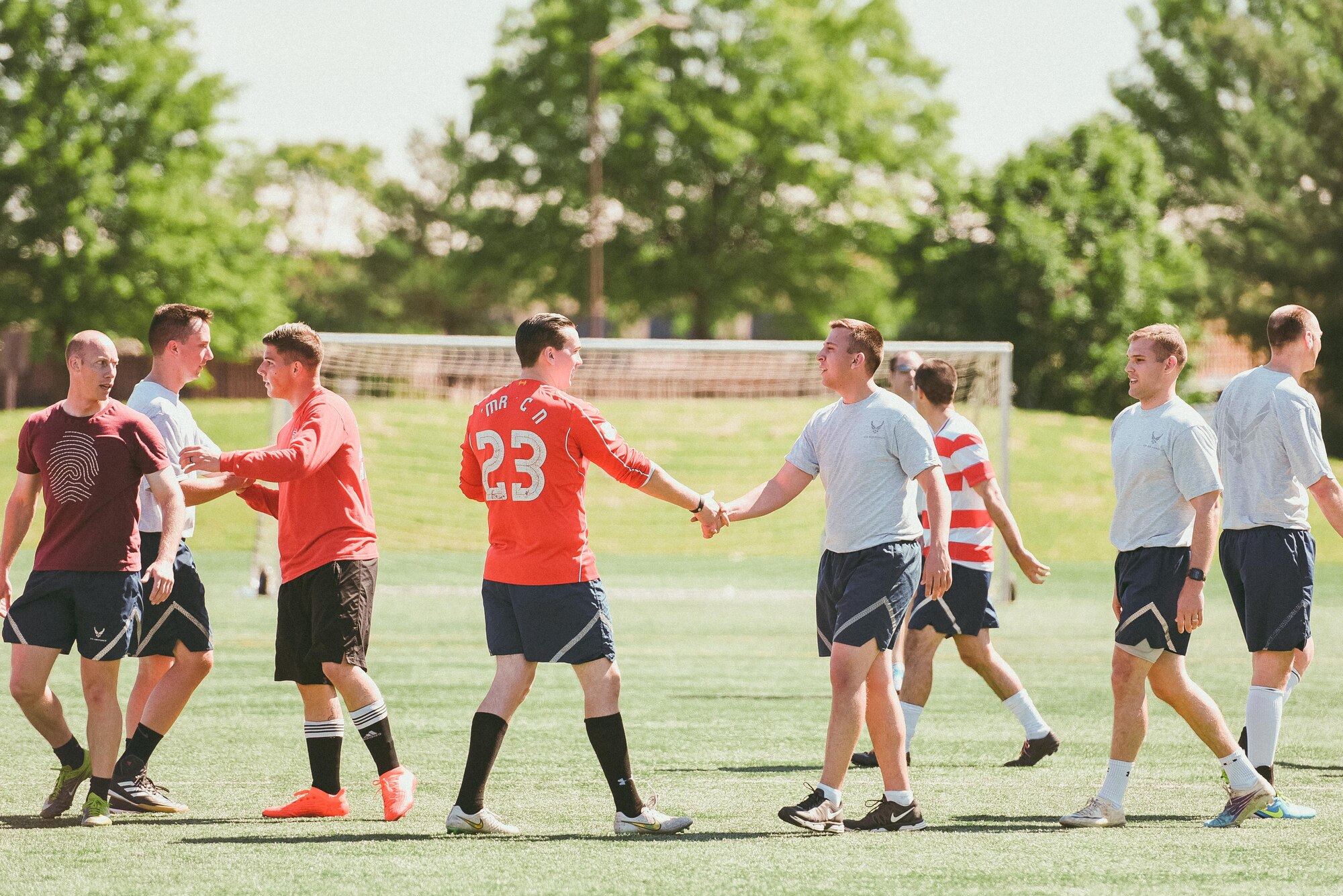 Airmen shake hands after playing a soccer game during Wingman/Shipmate Day at Joint Base Andrews, Md., May 16, 2017. Wingman/Shipmate Day is a day for Airmen to compete and strengthen the bonds between squadrons. (U.S. Air Force photo by Senior Airman Delano Scott)