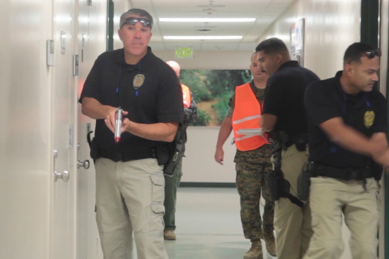 Officers from the Provost Marshal’s Office check rooms of Robert E. Bush Naval Hospital during an Active Shooter Full Scale Exercise aboard Marine Corps Air Ground Combat Center Twetynine Palms, Calif., May 16, 2017. The exercise allowed for the naval hospital, Provost Marshals Office, Fire Department and Naval Criminal Investigative Service to practice and assess their ability to detect, identify and respond to an active shooter incident, validating emergency response procedures. (U.S. Marine Corps photo by Cpl. Thomas Mudd)
