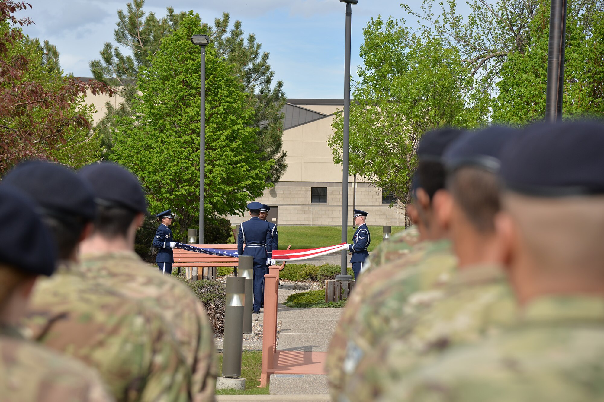 Members of the Malmstrom Base Honor Guard fold a flag at a retreat ceremony during National Police Week May 15, 2017, at Malmstrom Air Force Base, Mont. A flag was folded during the retreat ceremony to honor law enforcement members who have fallen in the line of duty. (U.S. Air Force photo/Airman 1st Class Daniel Brosam)