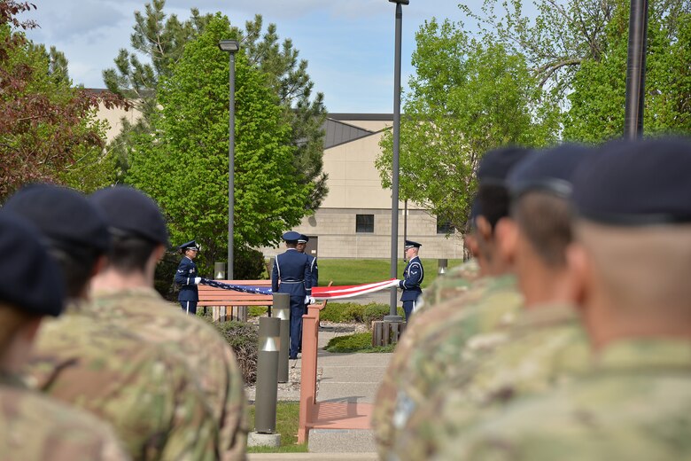 Members of the Malmstrom Base Honor Guard fold a flag at a retreat ceremony during National Police Week May 15, 2017, at Malmstrom Air Force Base, Mont. A flag was folded during the retreat ceremony to honor law enforcement members who have fallen in the line of duty. (U.S. Air Force photo/Airman 1st Class Daniel Brosam)
