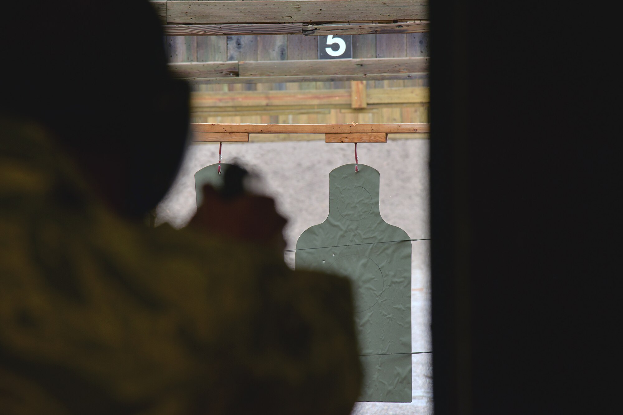 Senior Airman Raymond Dwoznick, 741st Missile Security Forces Squadron tactical response force assaulter, competes in an M-9 pistol shooting competition during National Police Week May 17, 2017, at Malmstrom Air Force Base, Mont. Airmen from the base, the Office of Special Investigations and local law enforcement participated in a shooting competition at the base’s combat arms training and maintenance range. (U.S. Air Force photo/Airman 1st Class Daniel Brosam)