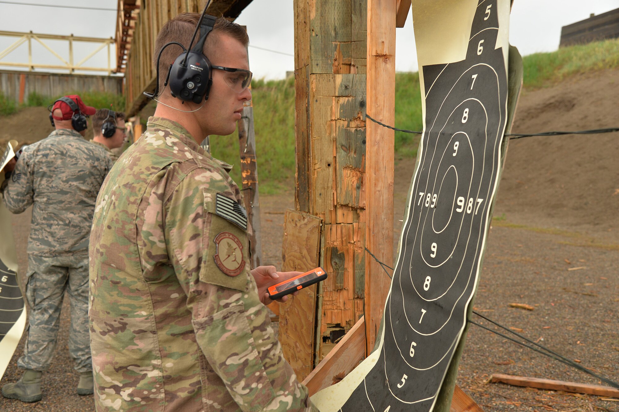 Staff Sgt. Alex Callahan, 741st Missile Security Forces Squadron tactical response force NCO in charge of the armory, counts points on a target at a shooting competition during National Police Week May 17, 2017, at Malmstrom Air Force Base, Mont. Participants in the shooting competition took turns performing different timed drills while accumulating points toward an overall score. (U.S. Air Force photo/Airman 1st Class Daniel Brosam)