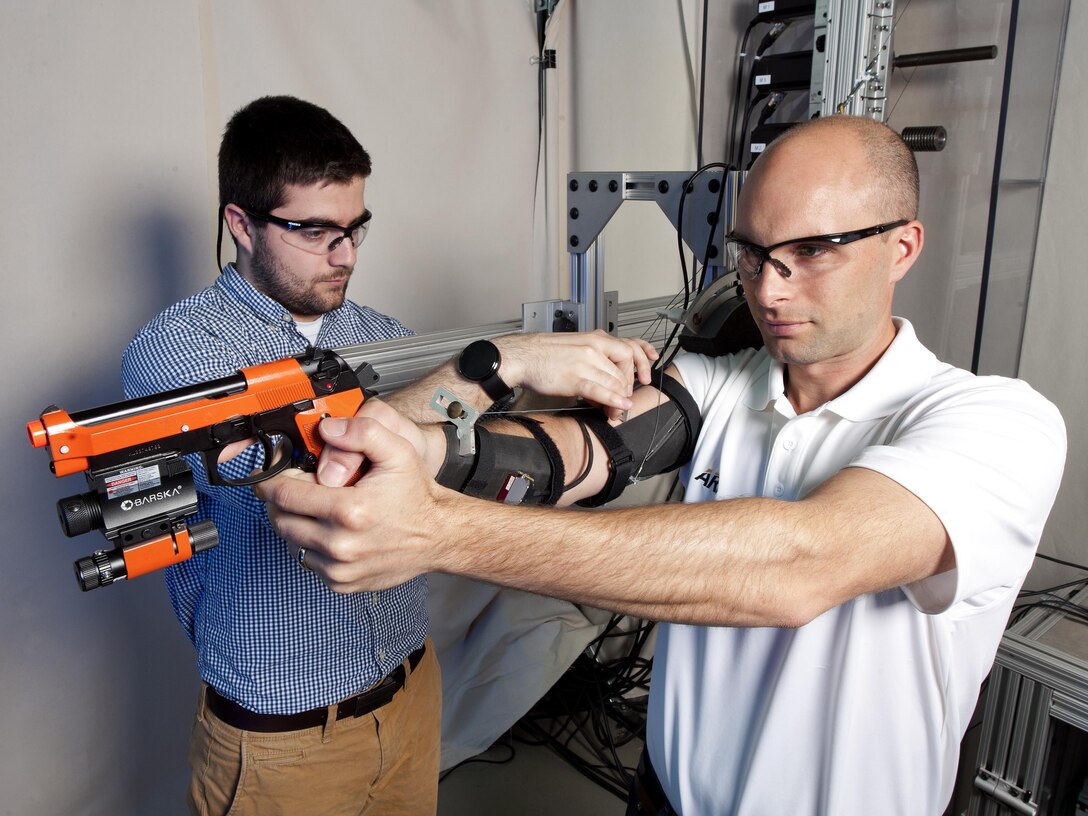 Researchers use high-speed motion sensor OptiTrack cameras mounted around the test area to monitor the mechatronic arm exoskeleton's effect on simulated shooting. Army photo by Doug LaFon