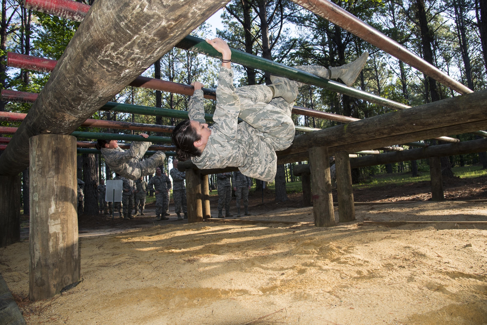 Commissioned Officer Training student maneuvers through an obstacle at the Officer Training School’s Vigilant Warrior training site, April 25, 2017, Maxwell Air Force Base, Ala. This was the first COT class to the Vigilant Warrior training site, instead of the High Ropes Course, in order to better align the course with the Total Force Officer Training course. (U.S. Air Force photo/ Senior Airman Alexa Culbert)
