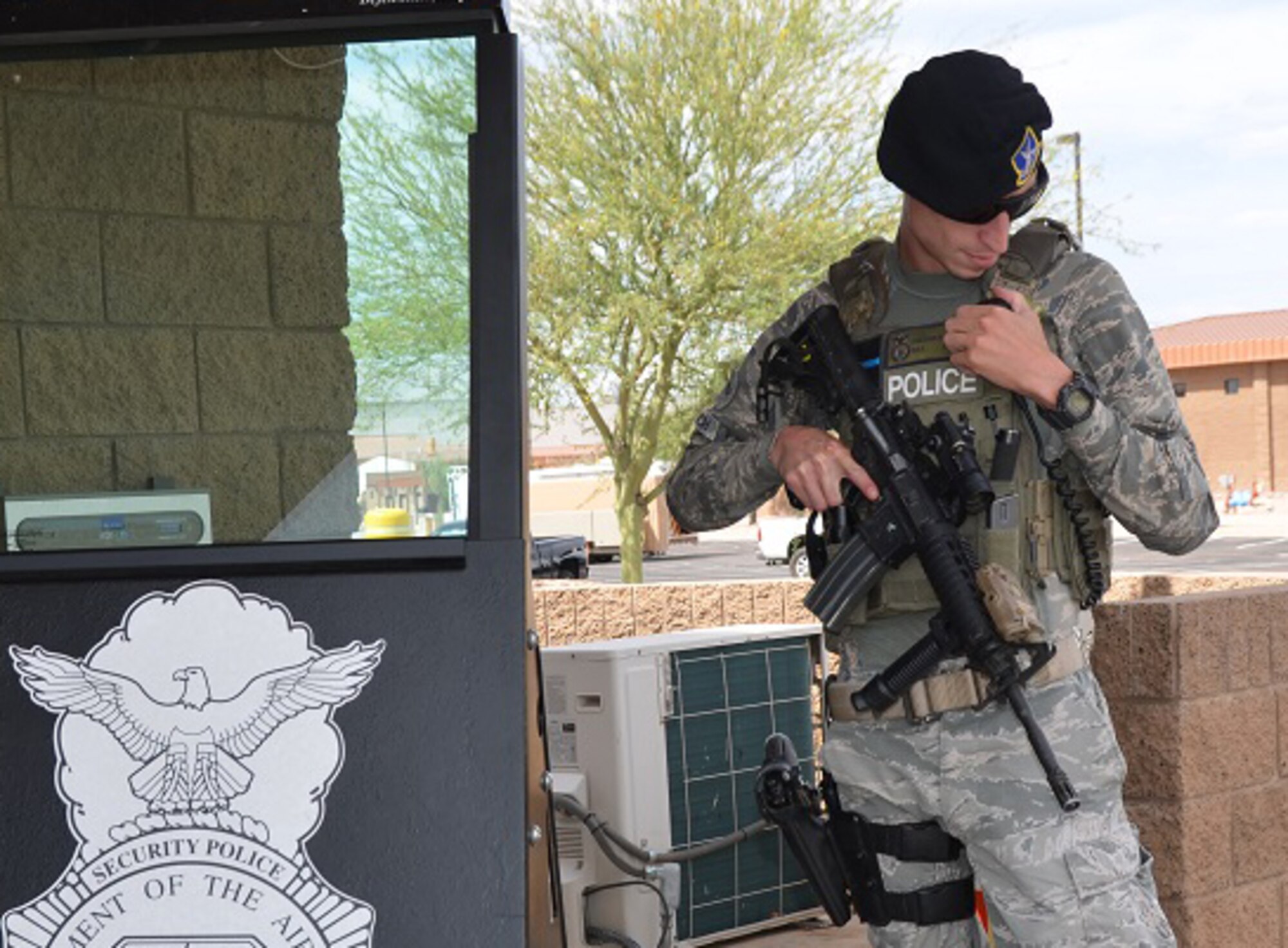 Senior Airman Jonathan Rockrich, a security forces specialist for the 161st Air Refueling Wing, calls for assistance while he controls access to Goldwater Air National Guard Base in Phoenix, May 14. Security forces members are part of a select few in the Arizona Air National Guard who meet the demands of a 24-hours-per-day operational mission; always ready to respond in defense of their state and nation. (U.S. Air National Guard photo by 2nd Lt. Tinashe Machona)