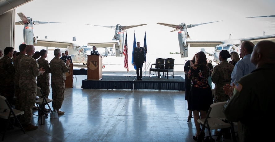 Maj. William Mendel, 20th Special Operations Squadron, stands at attention in front of a crowd attending his Distinguished Flying Cross ceremony at Cannon Air Force Base, N.M., May 15, 2017. Mendel’s aircraft, along with other aircraft in his formation, received heavy and effective hostile fire during a mission in Africa. Despite the significant damage to the aircraft, Mendel managed to complete the mission and save the lives of four critically wounded individuals onboard. He and other crew members were presented the Distinguished Flying Cross, a medal created in 1918 to reward those who display heroism or extraordinary achievement while participating in an aerial flight. Mendel became the 79th Airman under Air Force Special Operations Command to receive the honor. (U.S. Air Force photo by Senior Airman Lane T. Plummer)