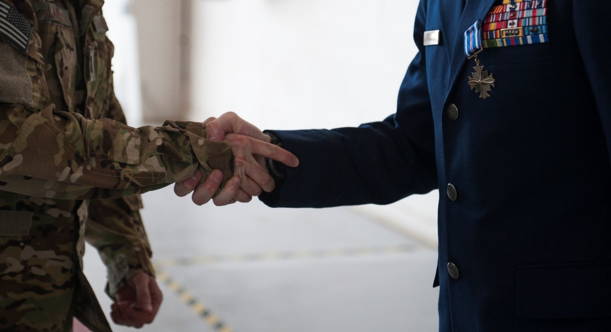 Maj. William Mendel, 20th Special Operations Squadron, shakes hands with another Airman after receiving the Distinguished Flying Cross, for his heroics during a mission in Africa, at Cannon Air Force Base, N.M., May 15, 2017. Mendel flew the CV-22 Osprey during the mission, and safely recovered his aircraft, crew and passengers despite severe damage received from heavy gunfire. (U.S. Air Force photo by Senior Airman Lane T. Plummer)