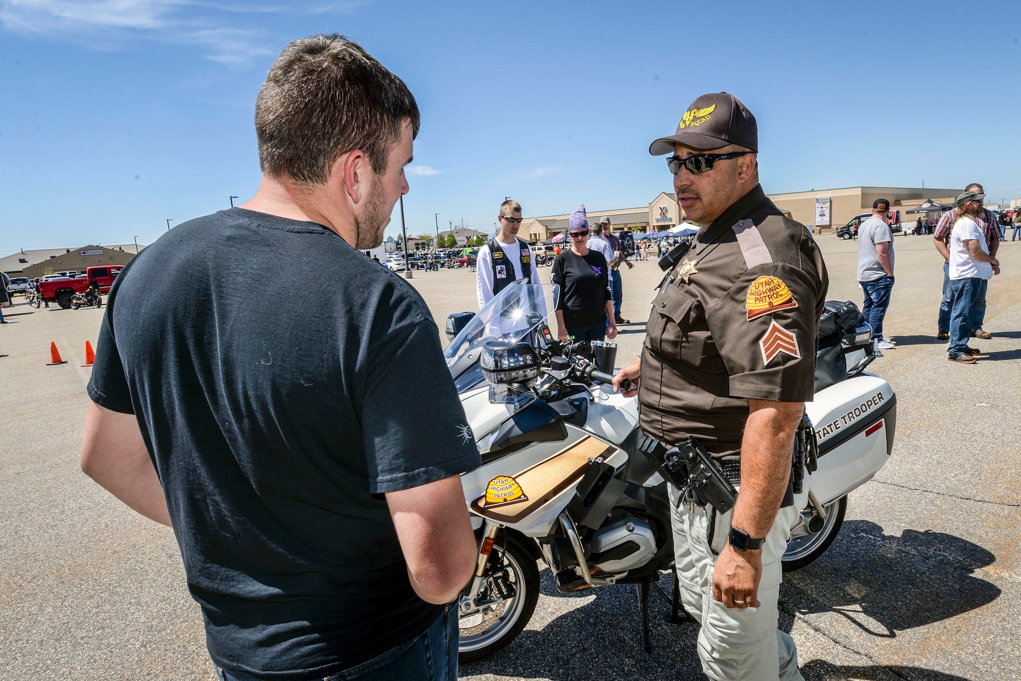 Sgt. Donavan Lucas of the Utah Highway Patrol talks motorcycle safety with a Hill Air Force Base employee, May 11. Besides safety briefings and demonstrations, Hill AFB’s 3rd Annual Motorcycle Rodeo featured food, vendor displays and radio programming. (U.S. Air Force/Paul Holcomb)