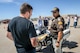 Sgt. Donavan Lucas of the Utah Highway Patrol talks motorcycle safety with a Hill Air Force Base employee, May 11. Besides safety briefings and demonstrations, Hill AFB’s 3rd Annual Motorcycle Rodeo featured food, vendor displays and radio programming. (U.S. Air Force/Paul Holcomb)