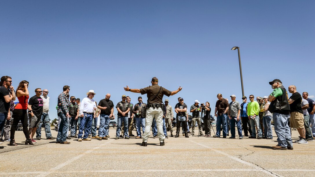 Sgt. Donavan Lucas of the Utah Highway Patrol talks motorcycle safety with a Hill Air Force Base employees May 11. Lucas also demonstrated emergency maneuvers such as high-speed braking during Hill AFB’s 3rd Annual Motorcycle Rodeo. (U.S. Air Force/Paul Holcomb)