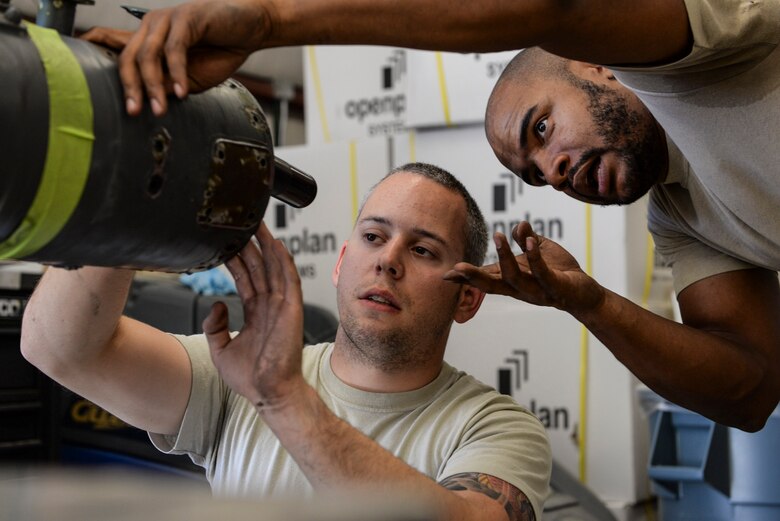 Staff Sgts. Lance Cissell and Cortez Brazill, 823rd Maintenance Squadron aircraft fuel systems craftsmen, inspect the inside of an HH-60G Pave Hawk helicopter’s fuel probe at Nellis Air Force Base, Nev., May 4, 2017. The fuel probe was identified to have damaged seals that leaked fuel. (U.S. Air Force photo by Airman 1st Class Andrew D. Sarver/Released)