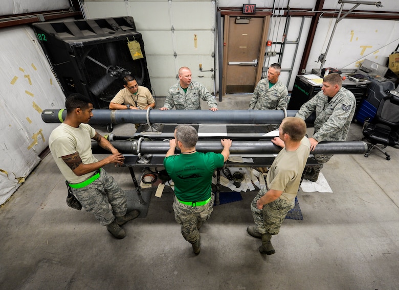 Airmen from the 823rd Maintenance Squadron discuss a plan of action for reassembling an HH-60G Pave Hawk helicopter fuel probe at Nellis Air Force Base, Nev., May 5, 2017. The fuel probe extends to almost double its normal length during the in-flight refueling process. (U.S. Air Force photo by Airman 1st Class Andrew D. Sarver/Released)