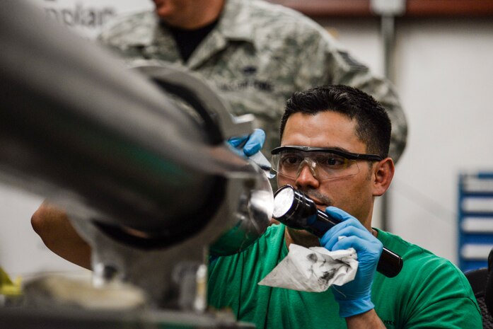 Tech. Sgt. Miguel Mascorro, 823rd Maintenance Squadron aircraft structural maintenance NCO in charge, performs adhesive repair on an HH-60G Pave Hawk helicopter’s fuel probe at Nellis Air Force Base, Nev., May 5, 2017. The old adhesive must be completely removed and the tube must be dry before setting the new adhesive down to ensure it will have a tight, clean seal to prevent fuel leaks. (U.S. Air Force photo by Airman 1st Class Andrew D. Sarver/ Released)