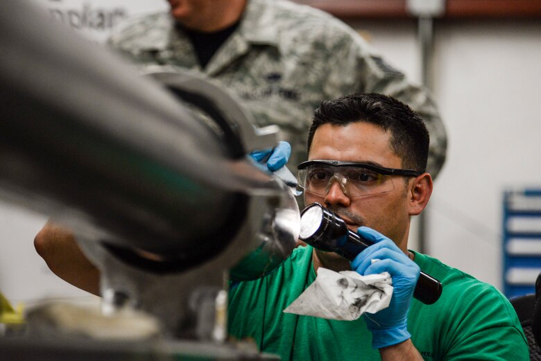 Tech. Sgt. Miguel Mascorro, 823rd Maintenance Squadron aircraft structural maintenance NCO in charge, performs adhesive repair on an HH-60G Pave Hawk helicopter’s fuel probe at Nellis Air Force Base, Nev., May 5, 2017. The old adhesive must be completely removed and the tube must be dry before setting the new adhesive down to ensure it will have a tight, clean seal to prevent fuel leaks. (U.S. Air Force photo by Airman 1st Class Andrew D. Sarver/ Released)