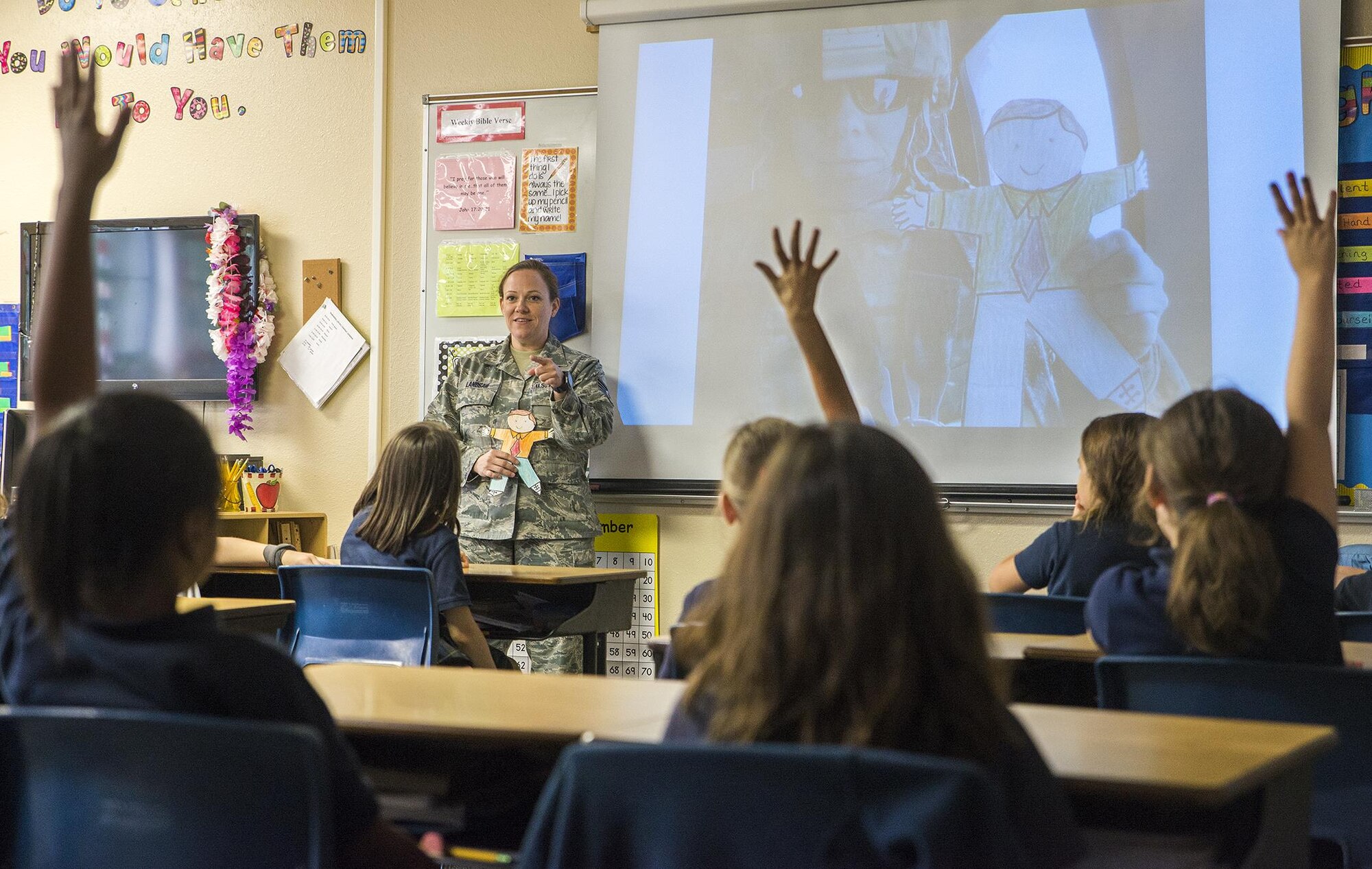 Staff Sgt. Candice Landsaw, 433rd Force Support Squadron system administrator, takes questions from 2nd grade students at Buckner Fanning School at Mission Springs May, 11, 2017. Landsaw took photos of Flat Stanley during her deployment to Al Udeid Air Base and and shared them with the students upon her return. (U.S. Air Force photo by Benjamin Faske)